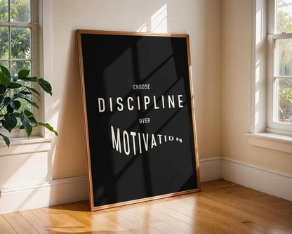 Framed poster with 'Choose Discipline Over Motivation' text in a bright room with windows and a plant.