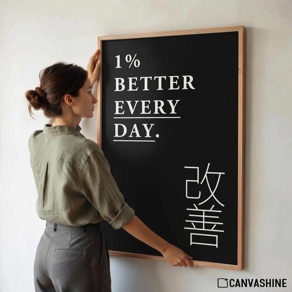 A woman in a sage green shirt and gray trousers stands beside a framed blackboard with the motivational phrase '1% BETTER EVERY DAY.' in white text and large white Japanese characters, against a plain light wall.