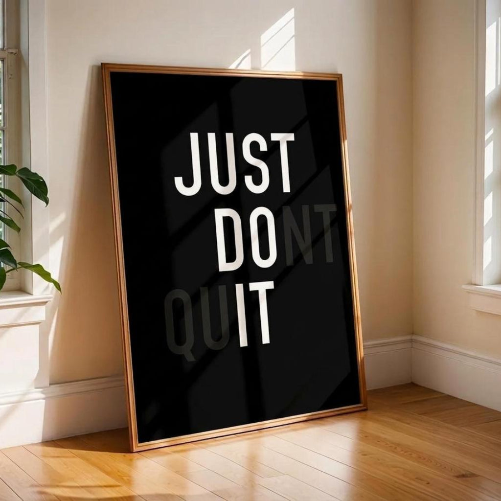 Framed poster with 'JUST DO IT' text in a room with windows and a plant.