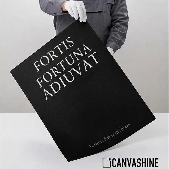 A person in a gray work jacket and white gloves holds a large black poster with white text reading 'FORTIS FORTUNA ADIUVAT' against a light gray studio background. The left side features a beige panel with text describing professional giclée quality, including archival paper, pigment ink, matte finish, and long-lasting design.