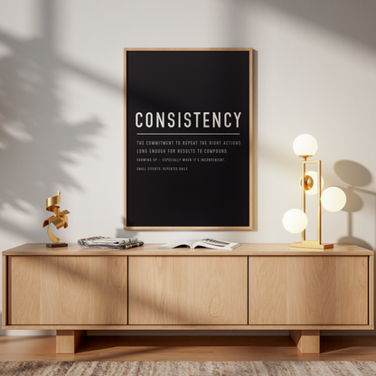 Wooden sideboard with 'The Matrix' poster above it in a room with a lamp and chair.