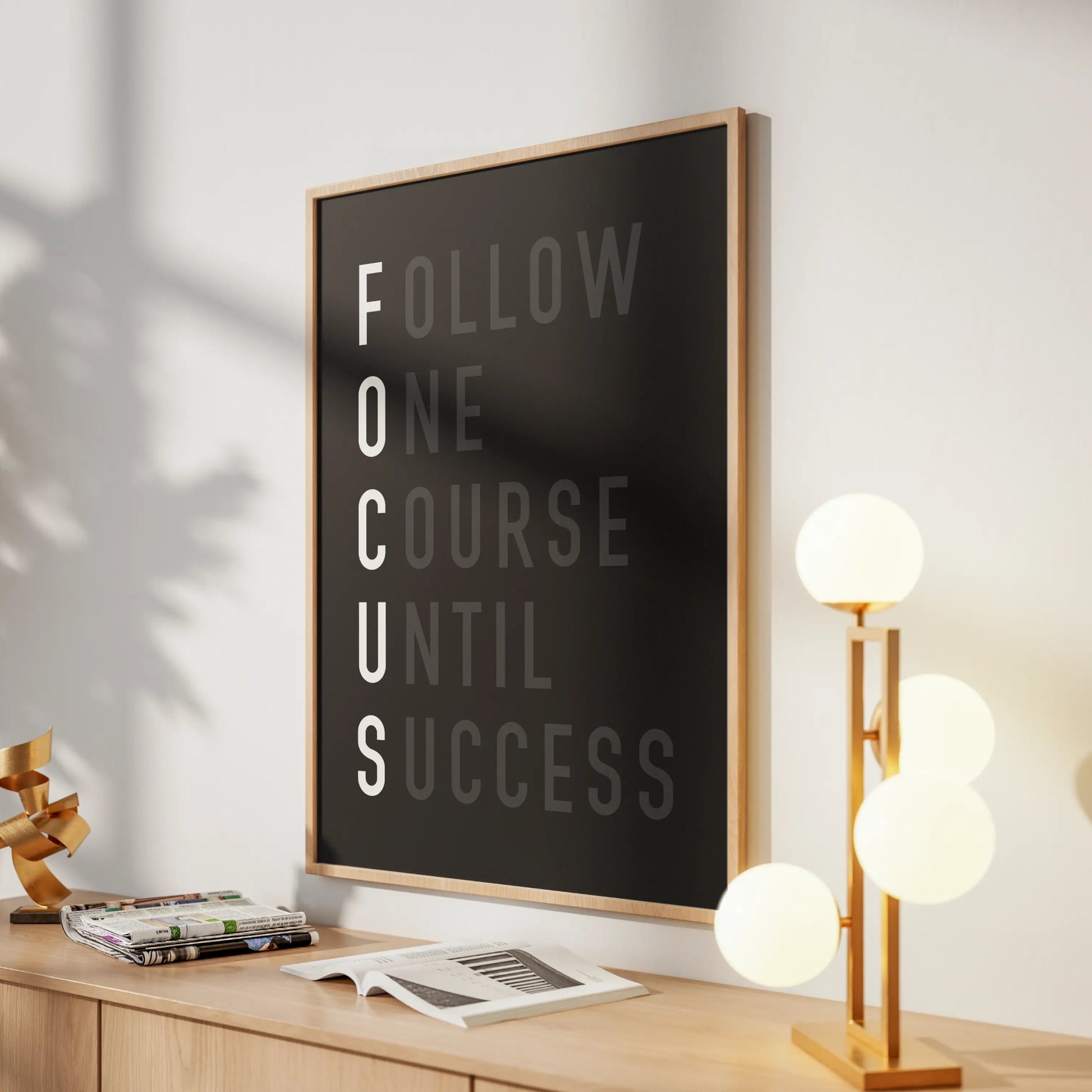 Motivational poster on a desk with a lamp and decor items