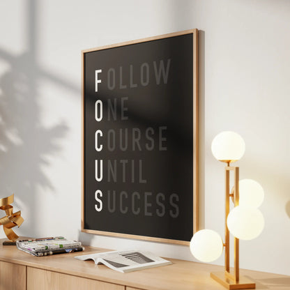 Motivational poster on a desk with a lamp and decor items