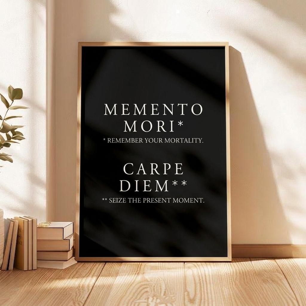 A framed wall art print leaning against a beige wall on a wooden floor, with sunlight casting shadows across the print and surrounding room. The print has a black background with white text reading 'MEMENTO MORI', 'AMOR FATI', and 'CARPE DIEM'.