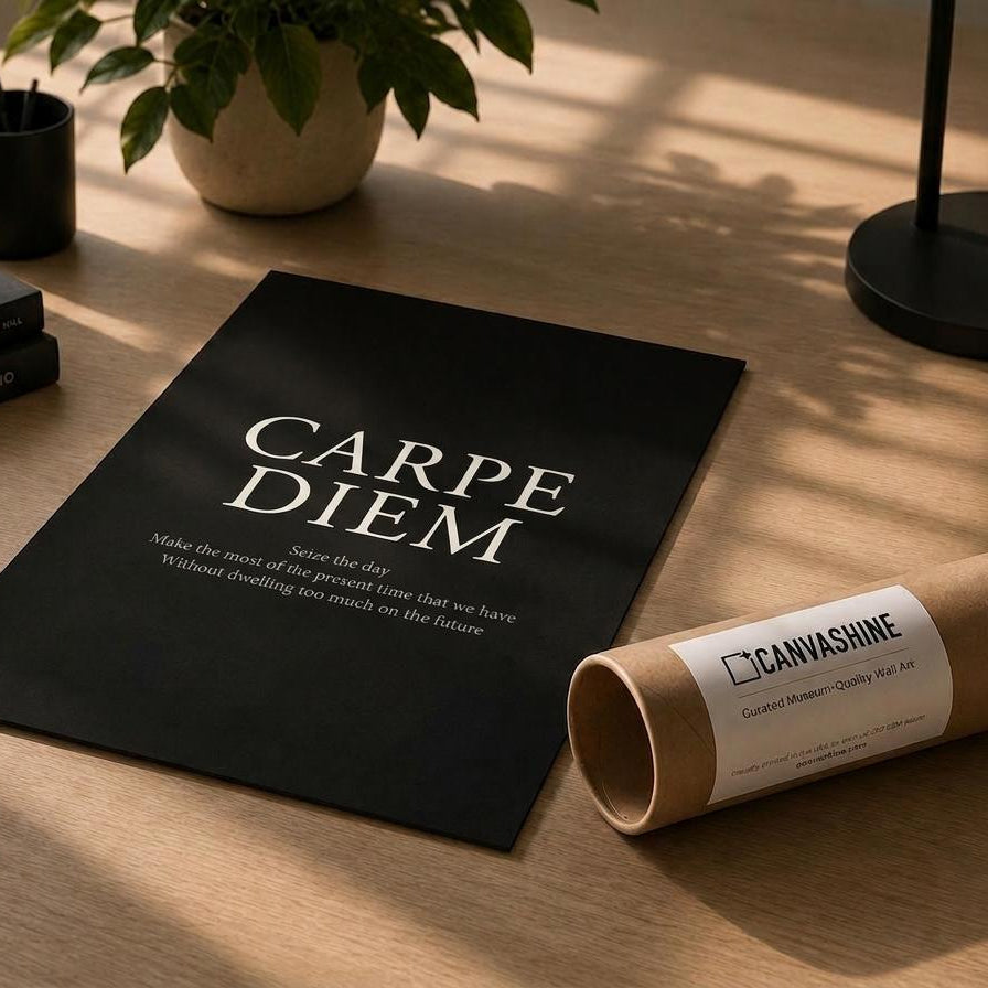 A black poster with the Latin phrase 'CARPE DIEM' in white serif text lies on a wooden desk, alongside a rolled kraft paper tube labeled CANVASHINE. The scene is styled with a potted plant, books, and a pen in warm natural light.